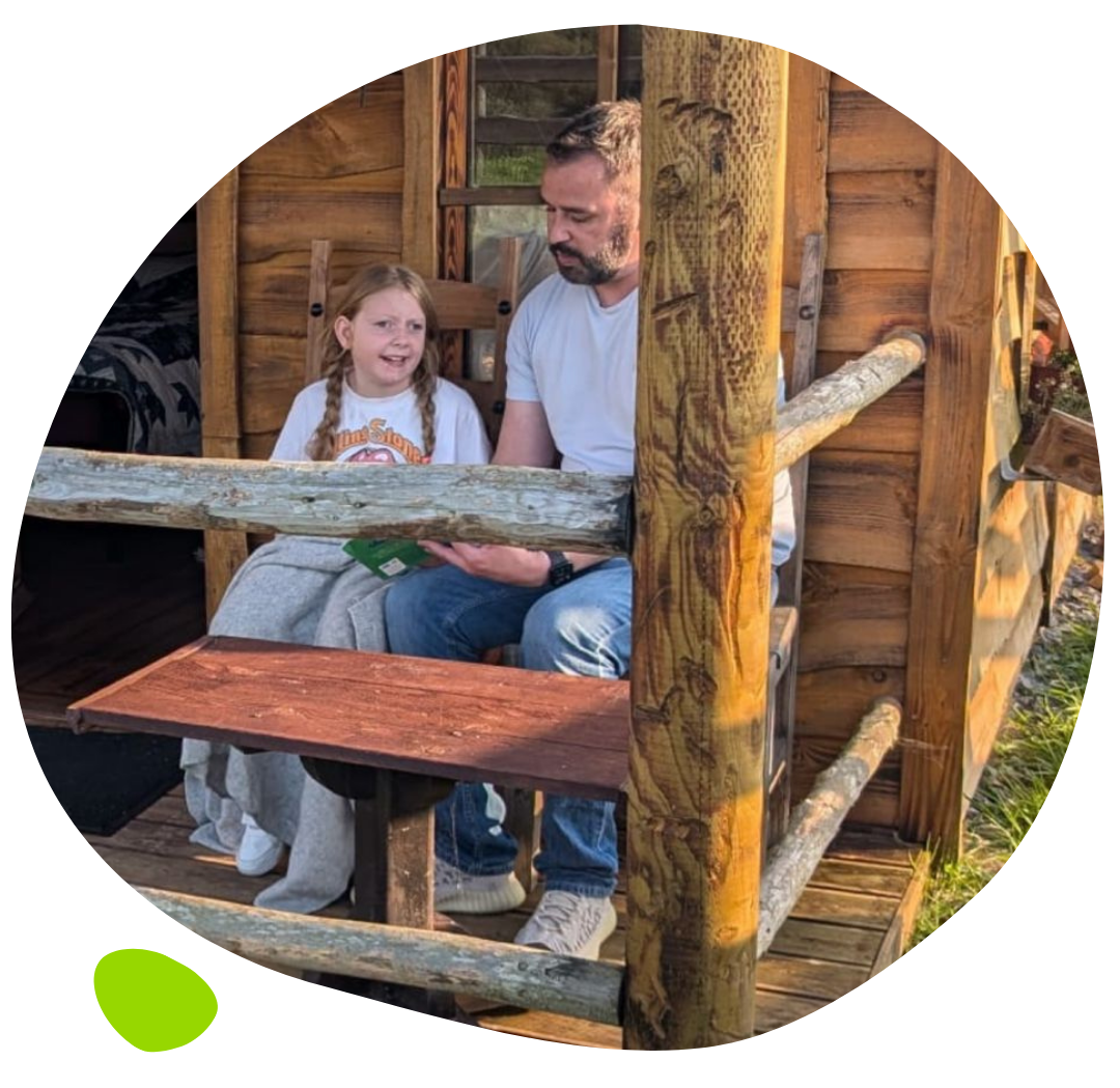 Daisy sitting in forrest with dad